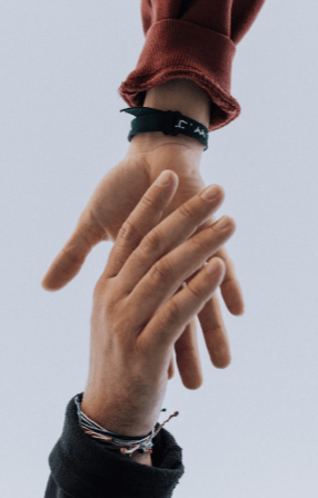 Two people reaching toward each other