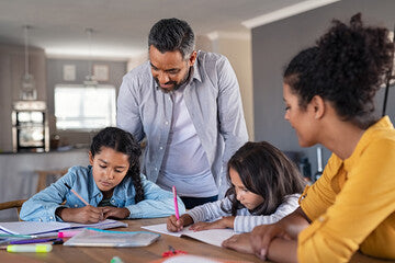 Children studying Spanish at home with their parents