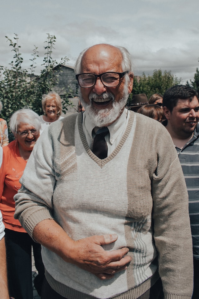 A smiling older adult traveling with a group