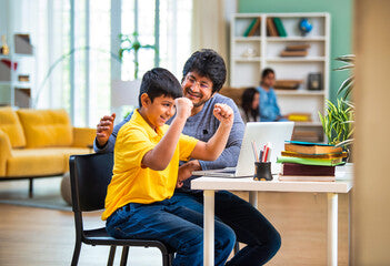 A parent encouraging a child during an at-home Spanish lesson