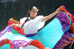 Mexican folk dancer wearing a colorful traditional dress