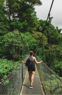Christy crossing a hanging bridge in the Costa Rican rainforest