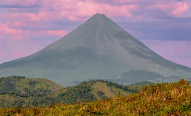 Arenal Volcano rising above the Costa Rican landscape at sunset