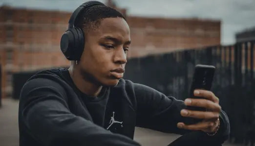 Learner practicing Spanish with a mobile app and headphones